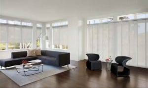 A modern living room with motorized shades covering the windows.