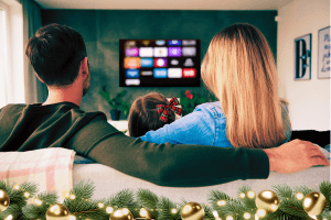 A family enjoys a football game in a modern, elegant media room with a large screen and comfortable seating.