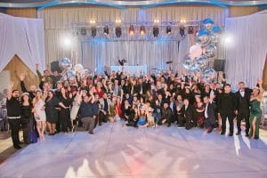 The Powerfull Systems team is depicted in a group picture at a company event.