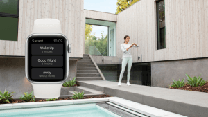 Woman exercising in a modern courtyard beside a pool, with a smartwatch interface displayed showing home automation scenes like “Wake Up,” “Good Night,” and “Away,” highlighting wearable control of a smart home.