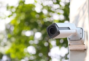 Exterior security camera mounted on wall for home surveillance system